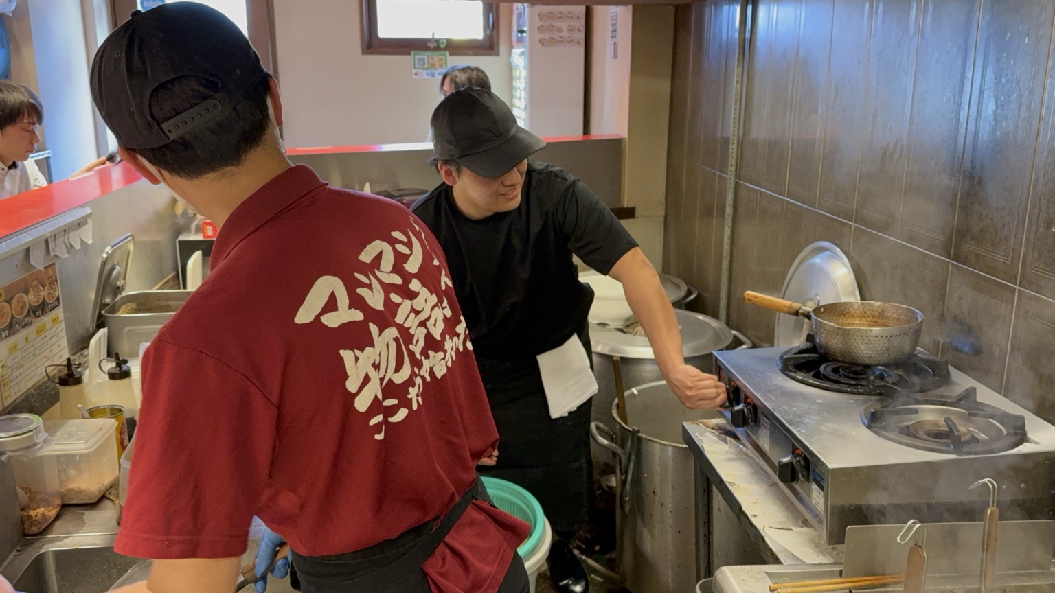 マシマシ物語の厨房で調理に向き合う人たち